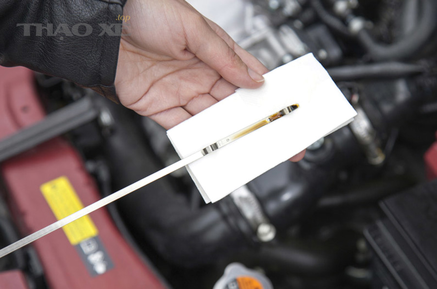 Chuẩn bị khăn sạch trước khi rút que thăm dầu động cơ