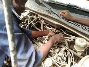 Mechanic repairing car engine