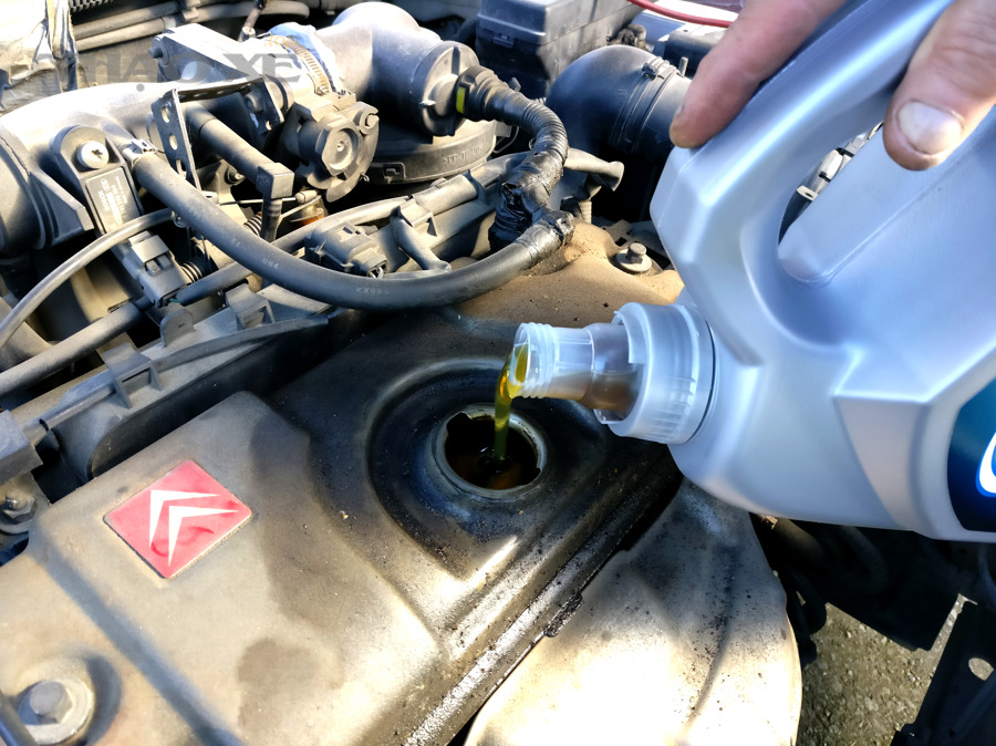 Pouring engine oil to motor