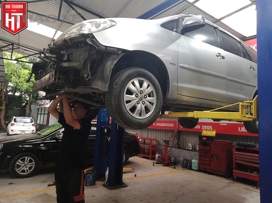 Ô tô đang được kiểm tra gầm xe và hệ thống treo trên cầu nâng